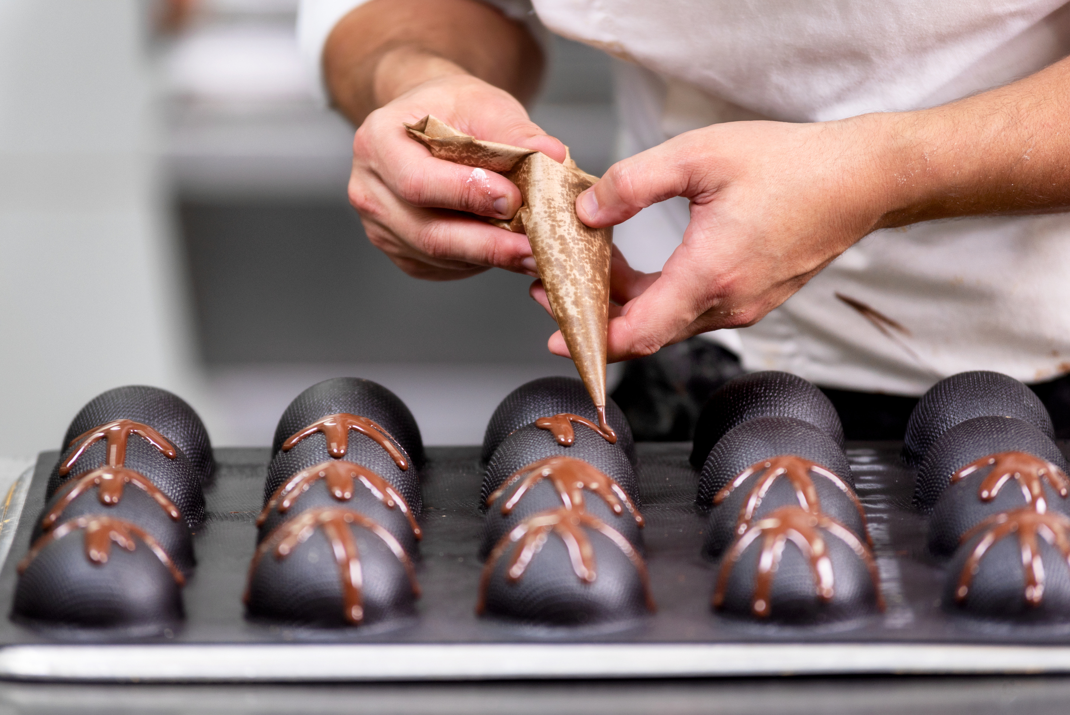 Professional confectioner making chocolate sweets at confectionery shop .Professional confectioner making chocolate sweets at confectionery shop .